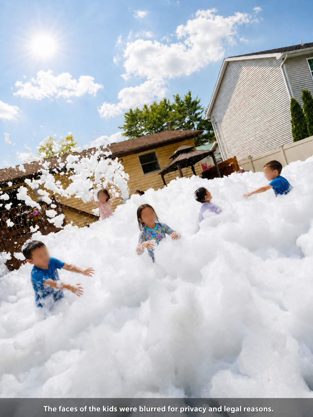 Small backyard foam party with kids playing
